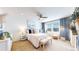 Bright bedroom featuring neutral decor, a ceiling fan, a window with neighborhood views, and stylish decor at 10016 Hough Pt, Parker, CO 80134
