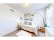 Bright bedroom with white walls, a floor lamp, neutral carpet, and coastal-themed decor at 10016 Hough Pt, Parker, CO 80134
