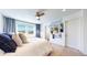 Comfortable bedroom featuring stylish décor, a ceiling fan, large window, and ample natural light at 10016 Hough Pt, Parker, CO 80134