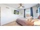 Well-lit bedroom featuring a ceiling fan, comfortable bed, and modern decor at 10016 Hough Pt, Parker, CO 80134