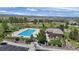 Community pool featuring many lounge chairs, a pool house, open green space, and views of the mountains in the distance at 10016 Hough Pt, Parker, CO 80134