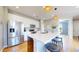 Modern kitchen with stainless steel appliances, white cabinetry, an island with seating, and hardwood floors at 10016 Hough Pt, Parker, CO 80134