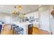 Bright kitchen with white cabinets, stainless steel appliances, an island with seating, and modern pendant lighting at 10016 Hough Pt, Parker, CO 80134