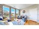 Cozy living room with hardwood floors, neutral tones, and large windows providing ample natural light and neighborhood views at 10016 Hough Pt, Parker, CO 80134