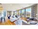Bright living room with large windows offering neighborhood views and comfortable seating, creating a welcoming atmosphere at 10016 Hough Pt, Parker, CO 80134