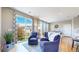 Comfortable living room with large sliding glass doors to backyard, hardwood floors, and stylish seating arrangements at 10016 Hough Pt, Parker, CO 80134