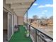 Cozy balcony features turf flooring, city views, and dark metal railings at 100 S Clarkson St # 303, Denver, CO 80209