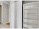 Walk-in closet with white shelving and ample storage space at 100 S Clarkson St # 303, Denver, CO 80209