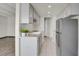 Galley kitchen featuring gray cabinets, stainless appliances, granite countertops, and tile flooring at 100 S Clarkson St # 303, Denver, CO 80209