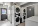 On-site laundry room has two stacked washer and dryer units for residents' use at 100 S Clarkson St # 303, Denver, CO 80209