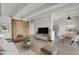 Bright living room featuring modern furniture, wood floors, a decorative sliding barn door, and an open concept to the kitchen at 100 S Clarkson St # 303, Denver, CO 80209