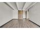 Bright living room featuring hardwood floors, high ceilings, and a decorative sliding barn door at 100 S Clarkson St # 303, Denver, CO 80209