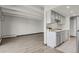 Living room featuring hardwood floors, high ceilings, and an open concept to a kitchen with light colored cabinets at 100 S Clarkson St # 303, Denver, CO 80209