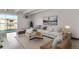 Bright living room featuring large windows, modern furniture, and a walk-out balcony with neighborhood views at 100 S Clarkson St # 303, Denver, CO 80209