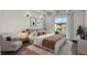 Bedroom features hardwood floors, abundant natural light, and balcony access at 100 S Clarkson St # 303, Denver, CO 80209