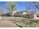 Fenced backyard featuring a deck and mature trees at 1255 Nelson St, Lakewood, CO 80215