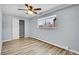 Cozy bedroom with a large window, wood-look floors, closet, and ceiling fan at 1255 Nelson St, Lakewood, CO 80215