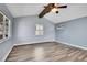A large bedroom with wood laminate flooring and large windows at 1255 Nelson St, Lakewood, CO 80215