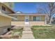 Charming home exterior with updated siding, brick, and professional landscaping at 1255 Nelson St, Lakewood, CO 80215