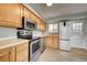 Modern kitchen featuring stainless steel appliances and light wood cabinetry at 1255 Nelson St, Lakewood, CO 80215
