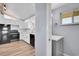 An airy kitchen with white countertops, stainless steel appliances and grey accent walls at 1255 Nelson St, Lakewood, CO 80215
