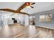 A spacious living room with wood laminate floors and an open view into the kitchen at 1255 Nelson St, Lakewood, CO 80215