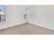 Well-lit bedroom featuring plush carpeting, neutral walls, and a bright window at 1050 S Monaco Pkwy # 77, Denver, CO 80224