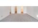 Carpeted bedroom featuring a closet and views of the en-suite bathroom at 1050 S Monaco Pkwy # 77, Denver, CO 80224