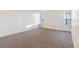 Bright bedroom with plush carpet, featuring two large windows that let in light at 1050 S Monaco Pkwy # 77, Denver, CO 80224