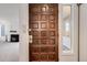 The front door opens to reveal a glimpse into the living room, including a cozy fireplace at 1050 S Monaco Pkwy # 77, Denver, CO 80224
