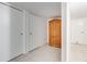 Bright hallway with tile floors, featuring built-in cabinets for extra storage at 1050 S Monaco Pkwy # 77, Denver, CO 80224
