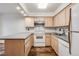 Efficient kitchen layout featuring wooden cabinets, modern appliances, and a functional countertop at 1050 S Monaco Pkwy # 77, Denver, CO 80224