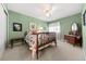 Bright bedroom with green walls featuring a queen-sized bed, neutral carpet, and curtains at 120 S Locust St, Denver, CO 80224