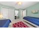 Bedroom featuring dual beds, carpet floors, and natural light from a window at 120 S Locust St, Denver, CO 80224