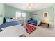 This bedroom showcases two beds, a red rug, and a large window, providing ample natural light at 120 S Locust St, Denver, CO 80224