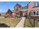 Charming brick two-story home with a small balcony and a beautifully manicured front yard at 120 S Locust St, Denver, CO 80224