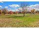 Picturesque grounds featuring mature trees, manicured lawns and walking paths under a sunny blue sky at 120 S Locust St, Denver, CO 80224