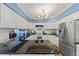 Kitchen showcasing black countertops, white cabinets, stainless steel appliances, and a chandelier at 120 S Locust St, Denver, CO 80224