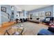 Spacious living room featuring wood floors, modern furniture, and natural light from the front windows at 120 S Locust St, Denver, CO 80224