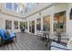 Outdoor patio with a black wood deck, neutral-toned exterior, and blue chairs and furniture at 120 S Locust St, Denver, CO 80224