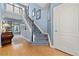 Elegant staircase featuring hardwood floors, a modern white railing, and soft blue walls at 120 S Locust St, Denver, CO 80224