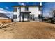 Home's backyard features well-maintained lawn, patio space, and a modern white exterior at 1314 Ascot Ave, Highlands Ranch, CO 80126