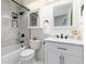 Updated bathroom with marble tile, bathtub, and sleek vanity with modern fixtures at 1314 Ascot Ave, Highlands Ranch, CO 80126