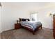Bright bedroom features a bed, a nightstand, and ample light from the window at 1314 Ascot Ave, Highlands Ranch, CO 80126