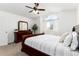 Bright bedroom features a ceiling fan, large window, and traditional furniture at 1314 Ascot Ave, Highlands Ranch, CO 80126