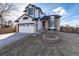 Charming two-story home with landscaped yard and inviting fire pit, perfect for outdoor entertaining at 1314 Ascot Ave, Highlands Ranch, CO 80126