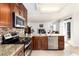 Open-concept kitchen with a view of the fireplace in the living room at 1314 Ascot Ave, Highlands Ranch, CO 80126