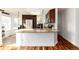 Stylish kitchen featuring a center island, stainless steel refrigerator, and warm wood flooring at 1314 Ascot Ave, Highlands Ranch, CO 80126