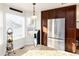 Bright kitchen featuring stainless steel refrigerator, granite countertops and plentiful natural light at 1314 Ascot Ave, Highlands Ranch, CO 80126
