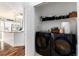 View from Laundry room into a bright kitchen featuring modern appliances and natural light at 1314 Ascot Ave, Highlands Ranch, CO 80126